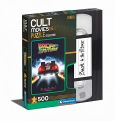 Boîte du puzzle Retour vers le futur 500 pièces de la collection Cult Movies par Clementoni, présentée dans un coffret original en forme de cassette VHS. La face avant montre la célèbre affiche du film avec la DeLorean laissant des traînées de feu sur la 